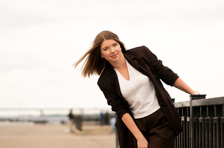 Young woman in brown suit posing