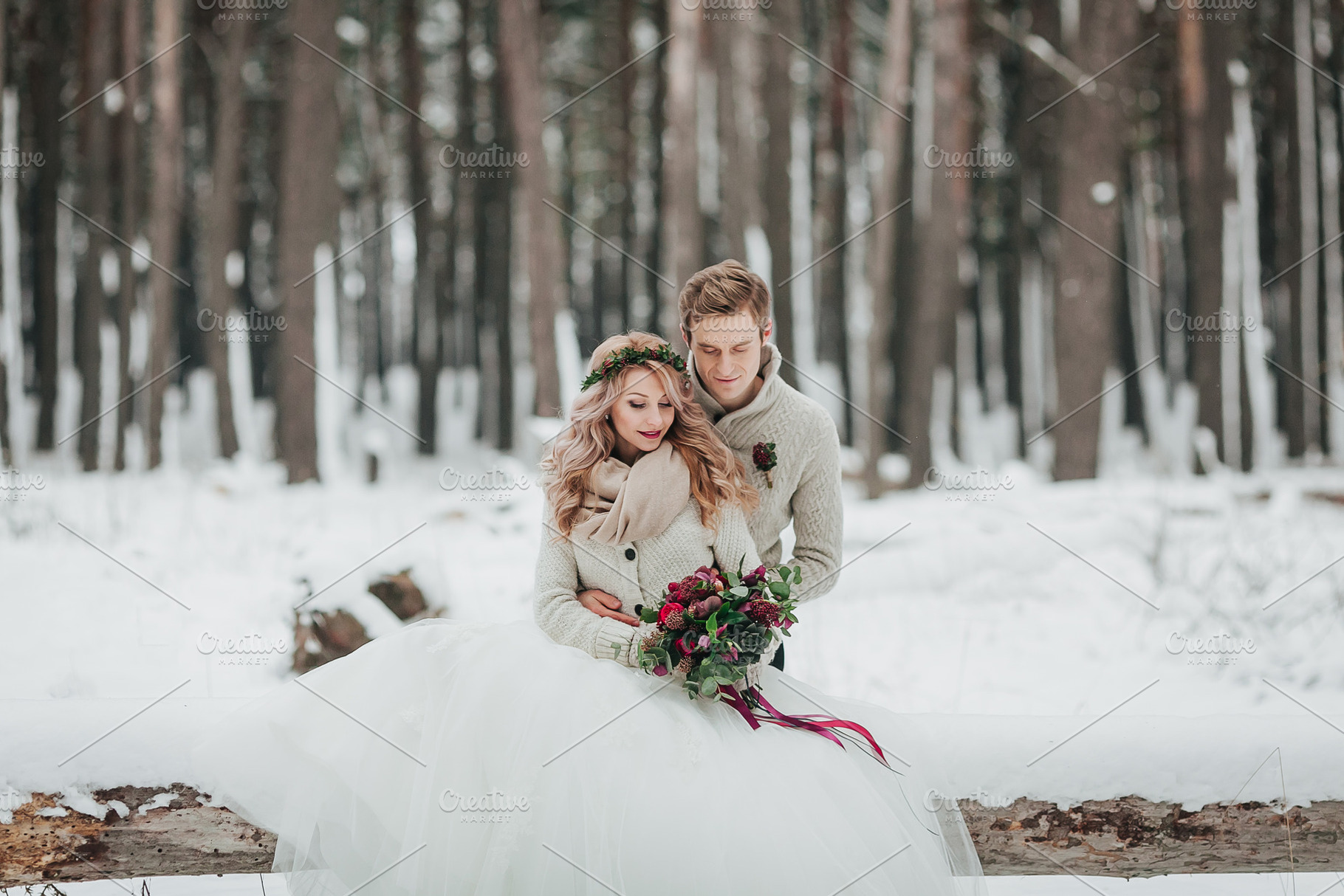 Bride and groom are sitting on the log in the winter forest. Close-up. Winter wedding ceremony., a Person Photo by Stahov