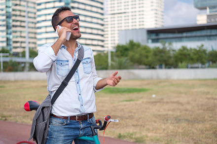 Handsome man talking on phone in modern city, a Person Photo by 2Design