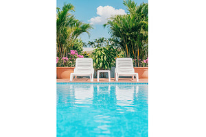Relaxing poolside chairs in tropical, a Nature Photo by Lermont51