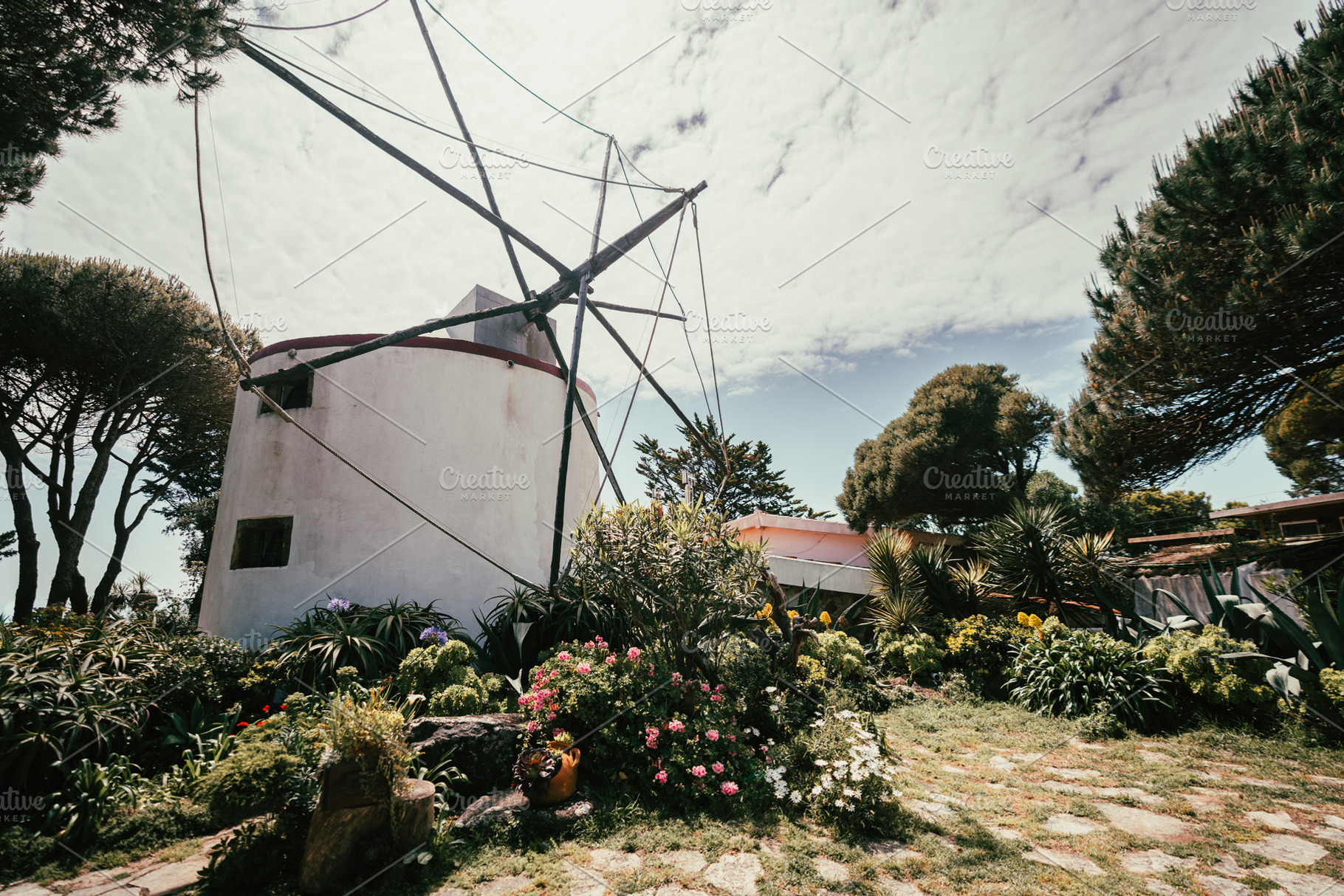 Windmill in lush garden landscape, an Architecture Photo by SkyNext