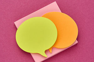 Multicolored thought cloud-shaped sticky notes on a square block, a Business Photo by ndanko
