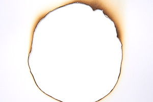 Burned hole within paper