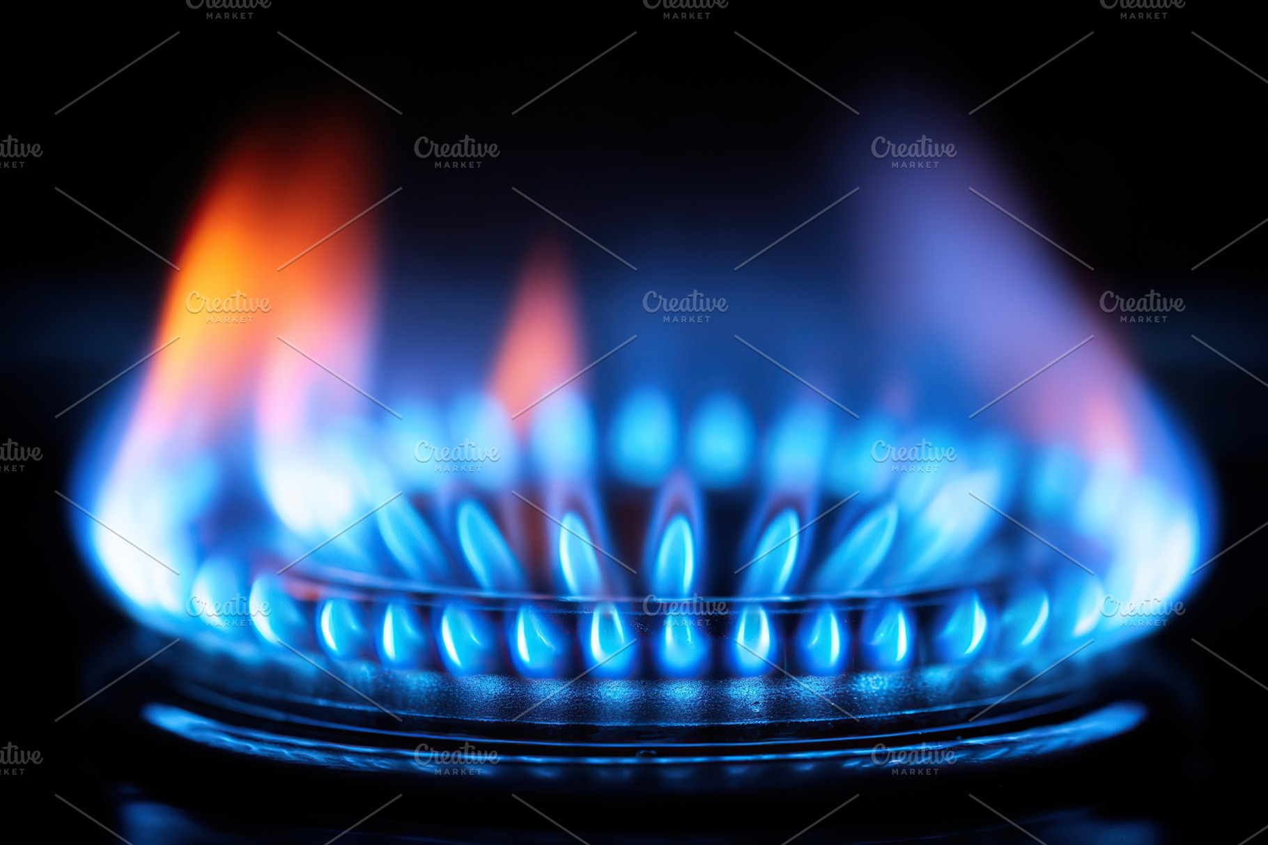 Bright blue flames dance on a gas stove during evening cooking in a warm kitche, an Arts & Entertainment Photo by AlyaAnd