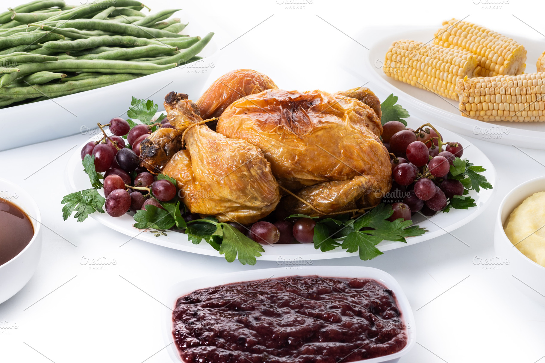 Thanksgiving dinner on rustic wooden table with turkey,mashed potatoes,ears of, a Food & Drink Photo by etorres69