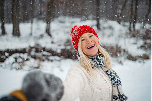 Happy elderly woman smiling outdoors, a Holiday Photo by HalfPoint