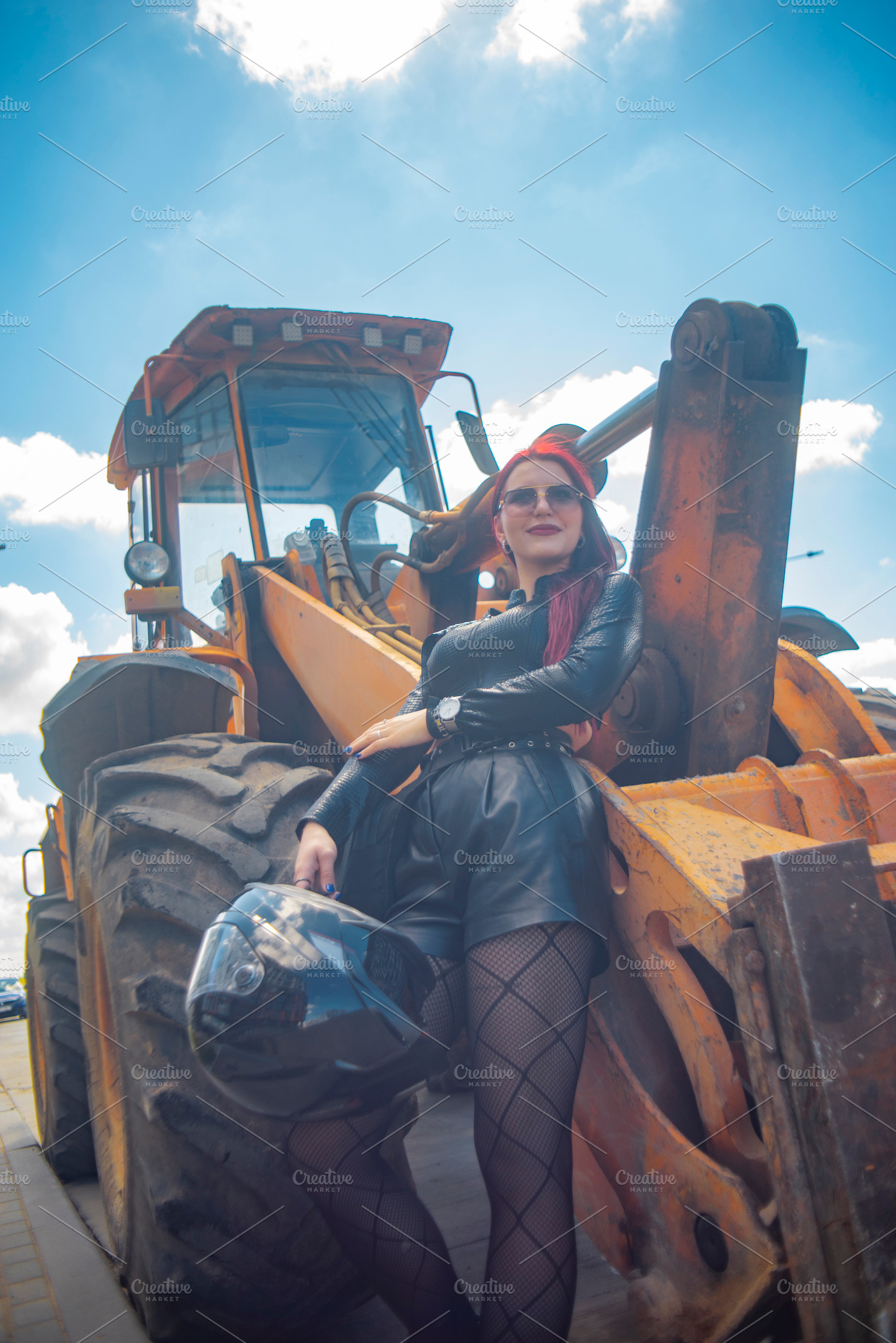 Low angle vertical portrait of red haired woman with helmet near, a Photo by Pictures for you!!!!!!!!!