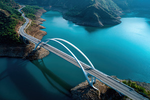 Scenic bridge over calm blue water, a Photo by Beautiful things
