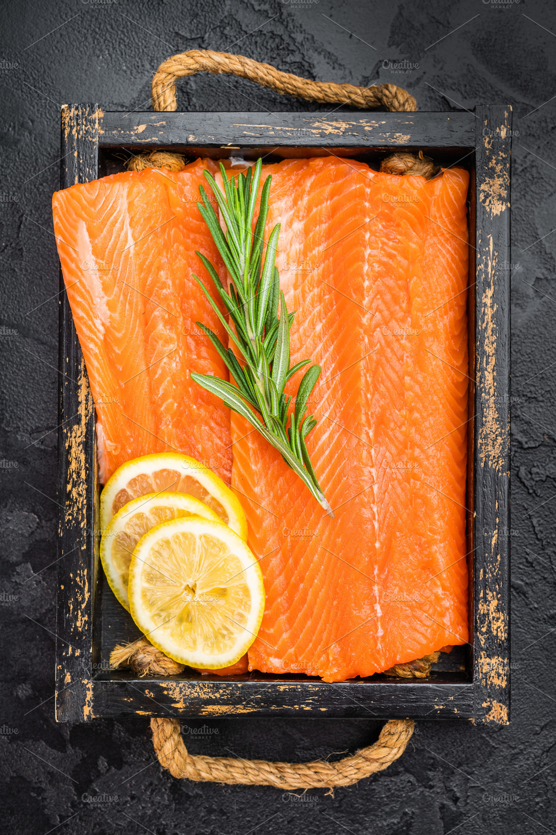 Uncooked salmon fillet with bright orange flesh rosemary and lem, a Food & Drink Photo by composter-box@mail.ru