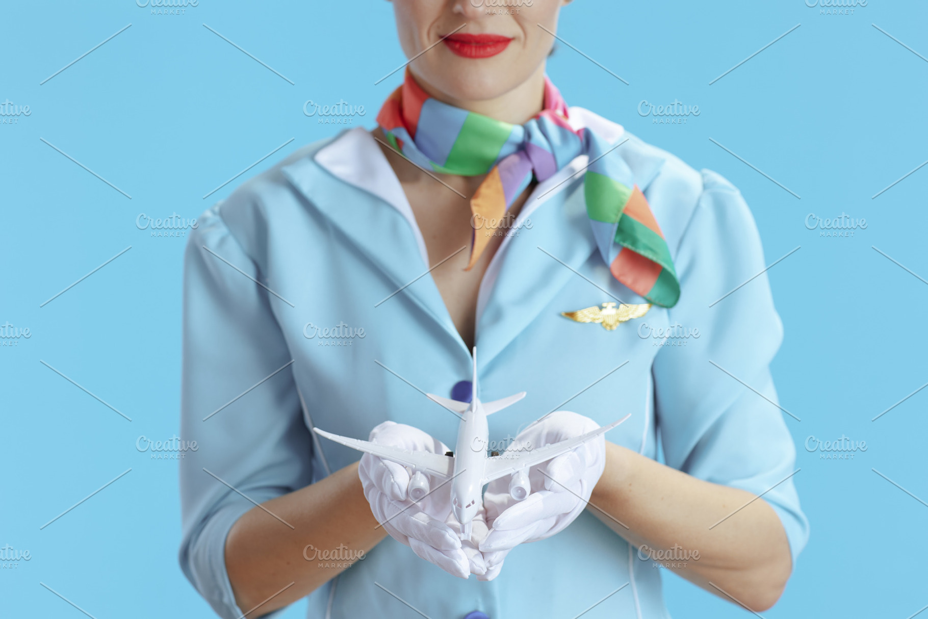 Closeup on stewardess woman on blue, a Business Photo by Alliance Images