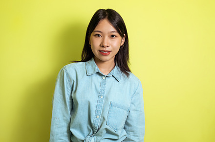 Portrait Of Attractive Japanese Young Woman Standing Over Yellow Background, a Person Photo by Prostock-Studio