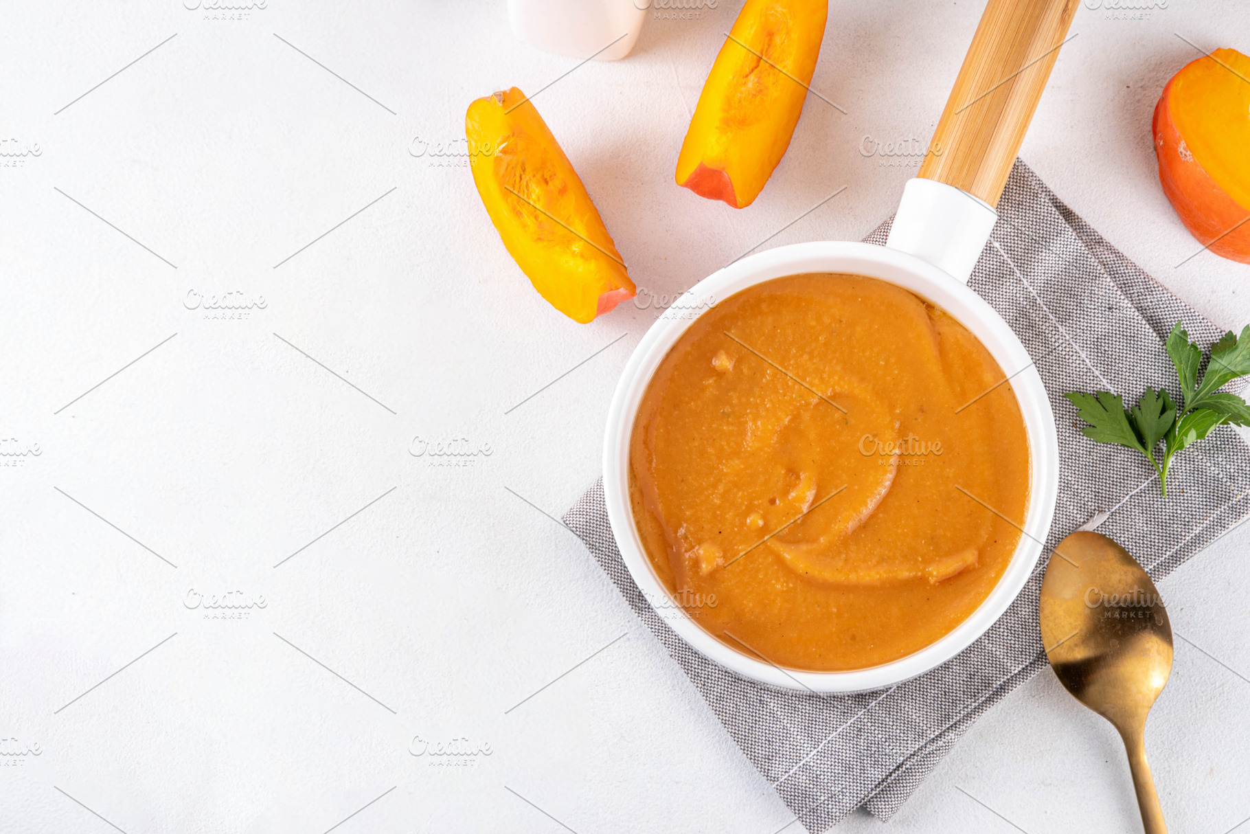 Pumpkin creamy soup served in white bowl, a Food & Drink Photo by Rimma