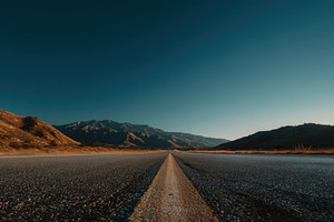 Road through mountains at sunset, a Photo by Beautiful things