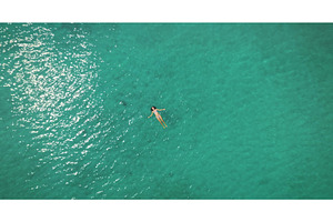 Woman floating in clear turquoise, a Person Photo by Goinyk