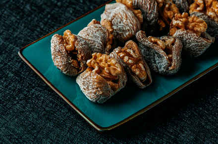 plate with spanish dried figs filled with walnuts, a Photo by Nito