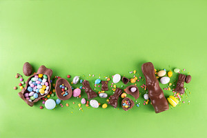 Easter eggs, bunny and rabbits on bright green background, a Holiday Photo by Rimma