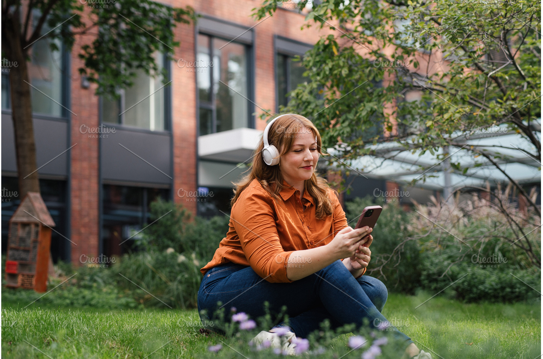Confident woman relaxing, listening, a Nature Photo by HalfPoint