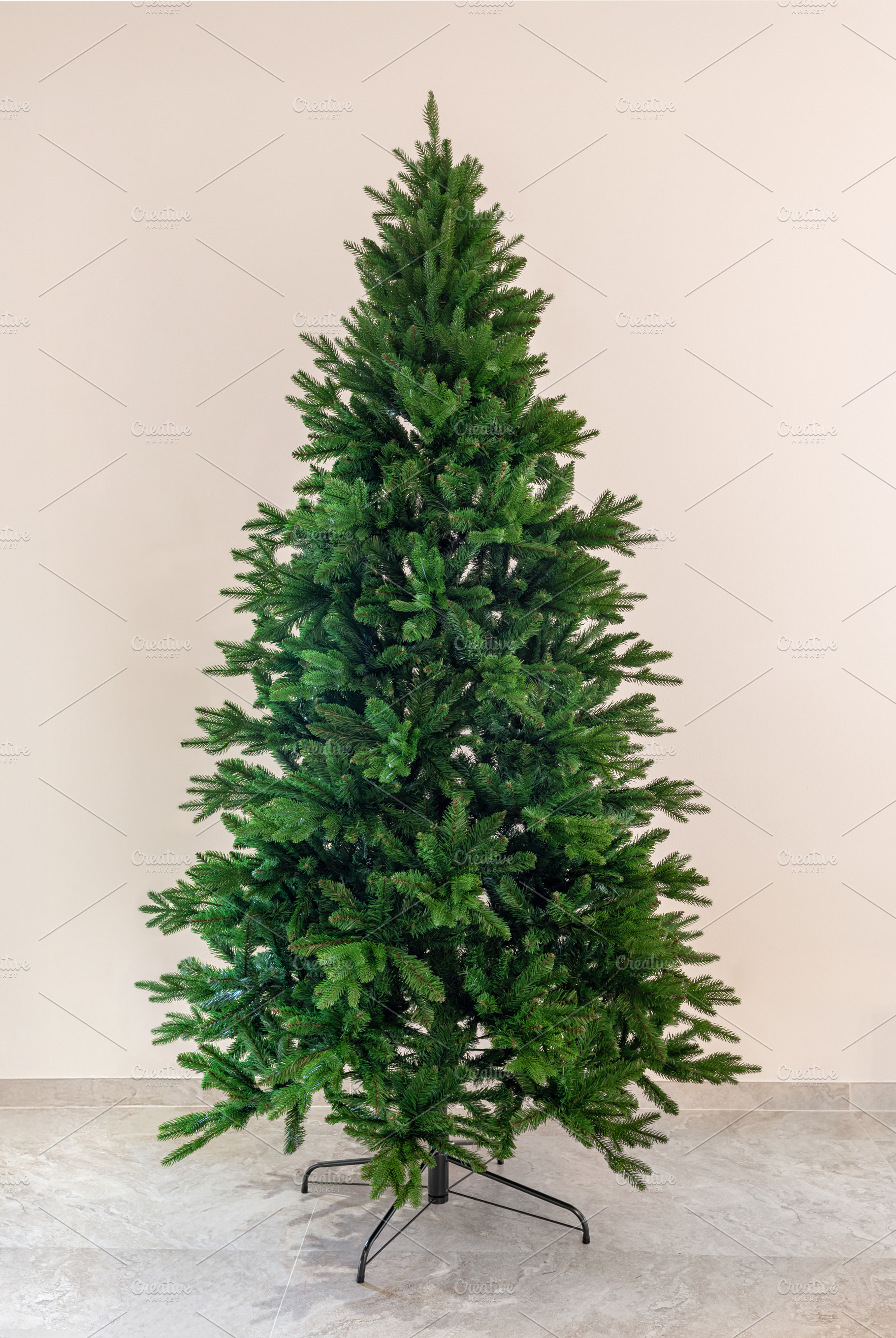 Artificial green Christmas tree standing bare before holiday decorating, a Holiday Photo by Antonio Gravante Market