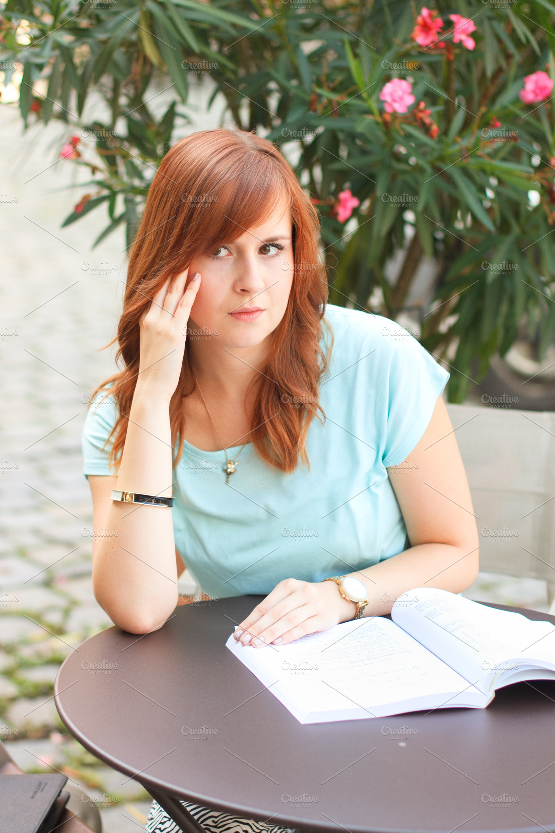 Woman sitting at the cafe with book