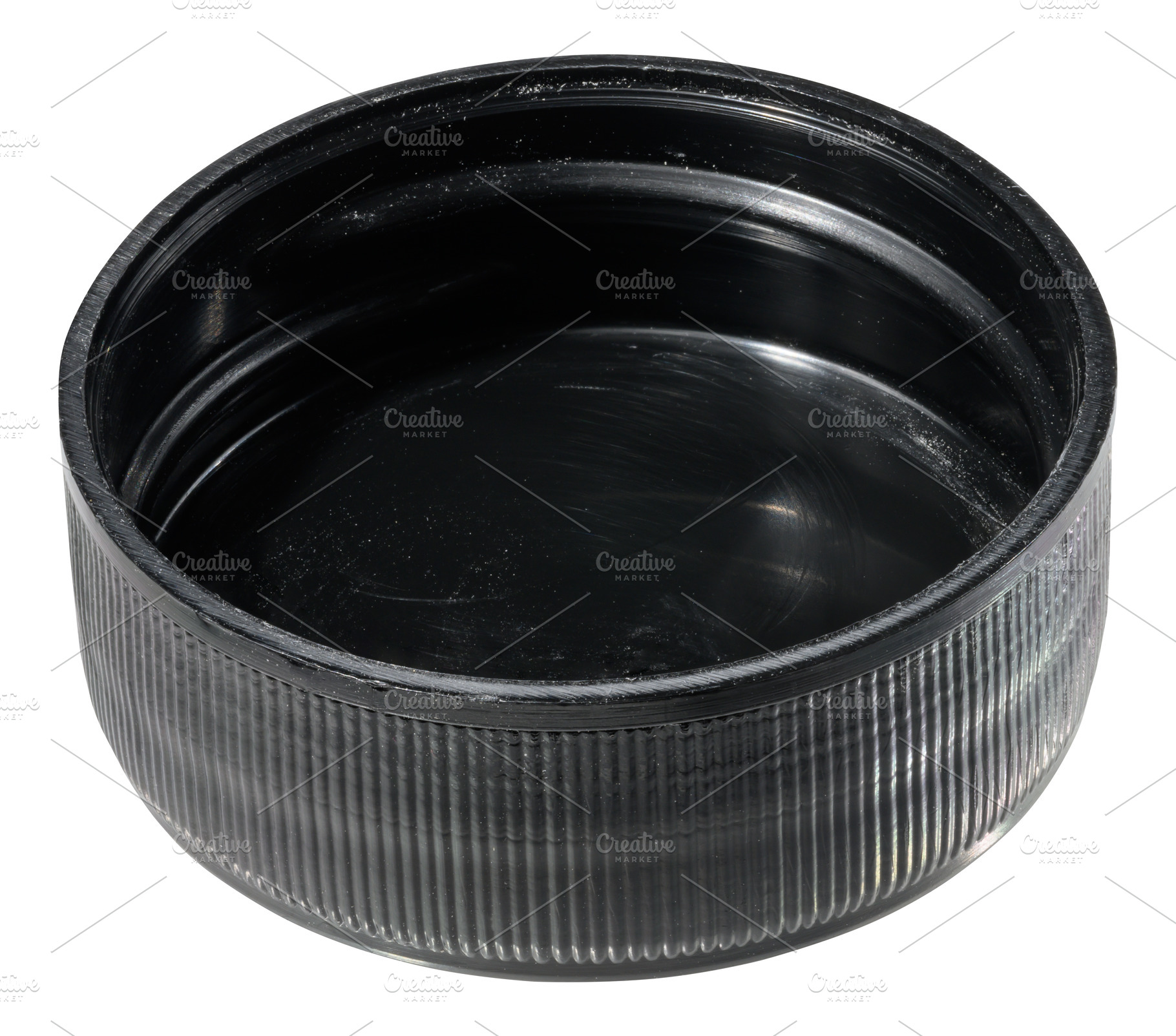 A round, black plastic bottle cap with a ribbed exterior and a s, an Industrial Photo by ndanko