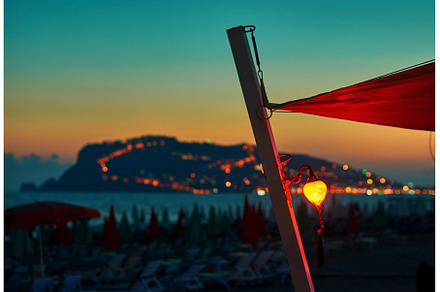 Lantern on the beach at sunset with, a Holiday Photo by Oleksandr Berezko