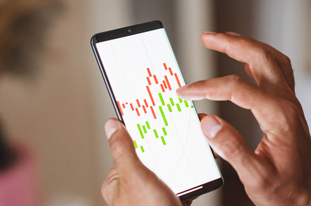 Man working with graphs on a device