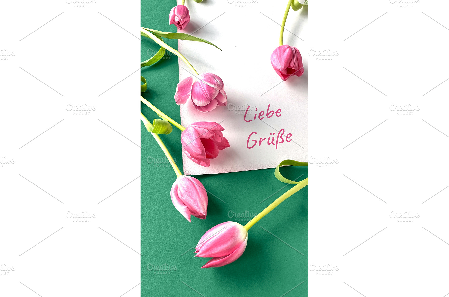 Pink tulips with a white card, a Photo by tilialucida