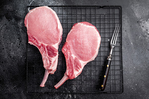 Fresh pork Chop Tomahawk steak, showcasing its impressive bone a, a Food & Drink Photo by composter-box@mail.ru