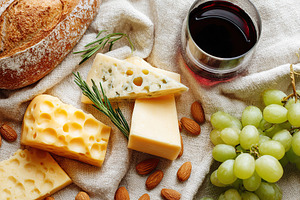 Delightful cheese platter featuring soft and hard cheeses with accompaniments, a Food & Drink Photo by AlyaAnd