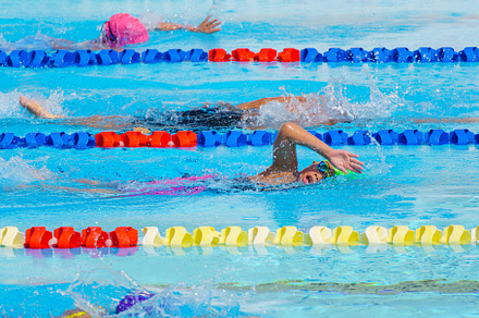 Swimmer child swims backstroke swimm