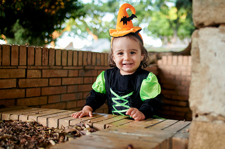 Baby in halloween costume playing ou