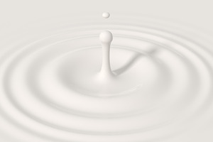 Drop falling into cream or milk