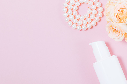 Bouquet of fresh roses next to pearl necklace and bottle of cosm, a Beauty & Fashion Photo by progressman
