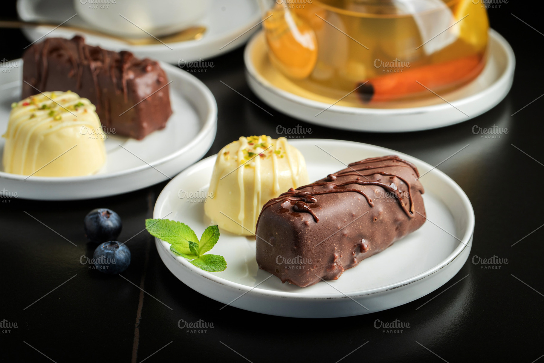 Delicious glazed curd snacks with fresh blueberries and mint on, a Food & Drink Photo by Budarinphoto