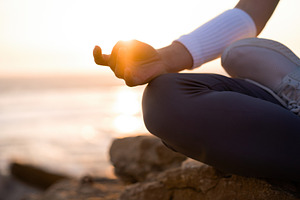 Woman practice yoga lotus pose to meditation with summer vacation rocky beach h, a Person Photo by andreonegin market