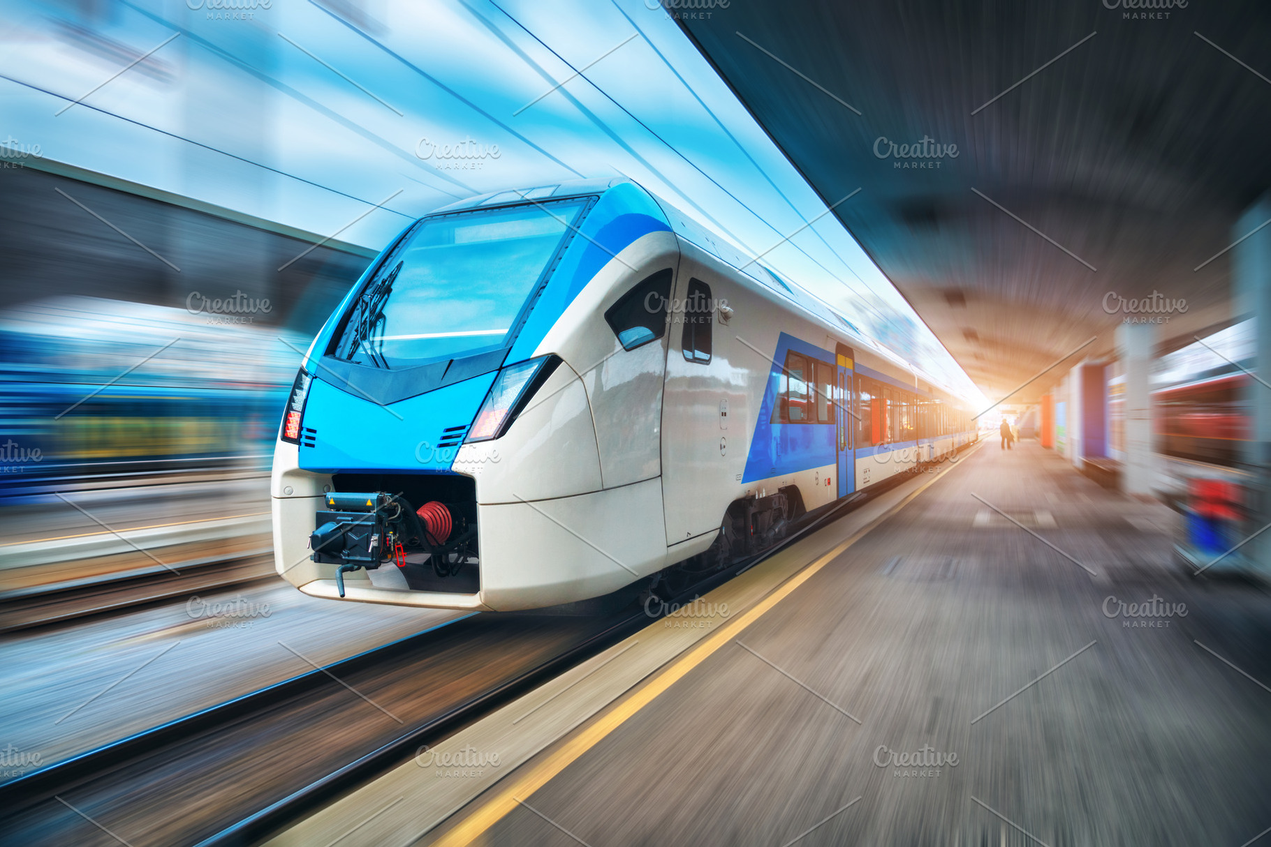 High speed train in motion on the railway station at sunset, a ...