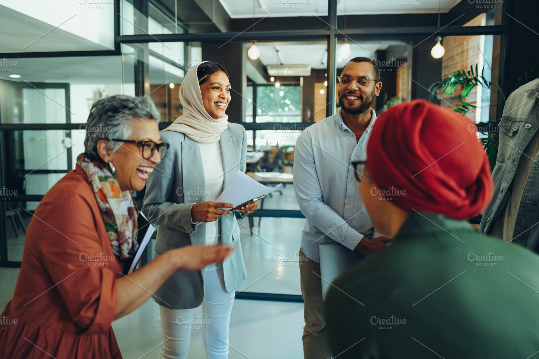 Group of happy businesspeople laughing cheerfully in an office, a Person Photo by Jacob Lund