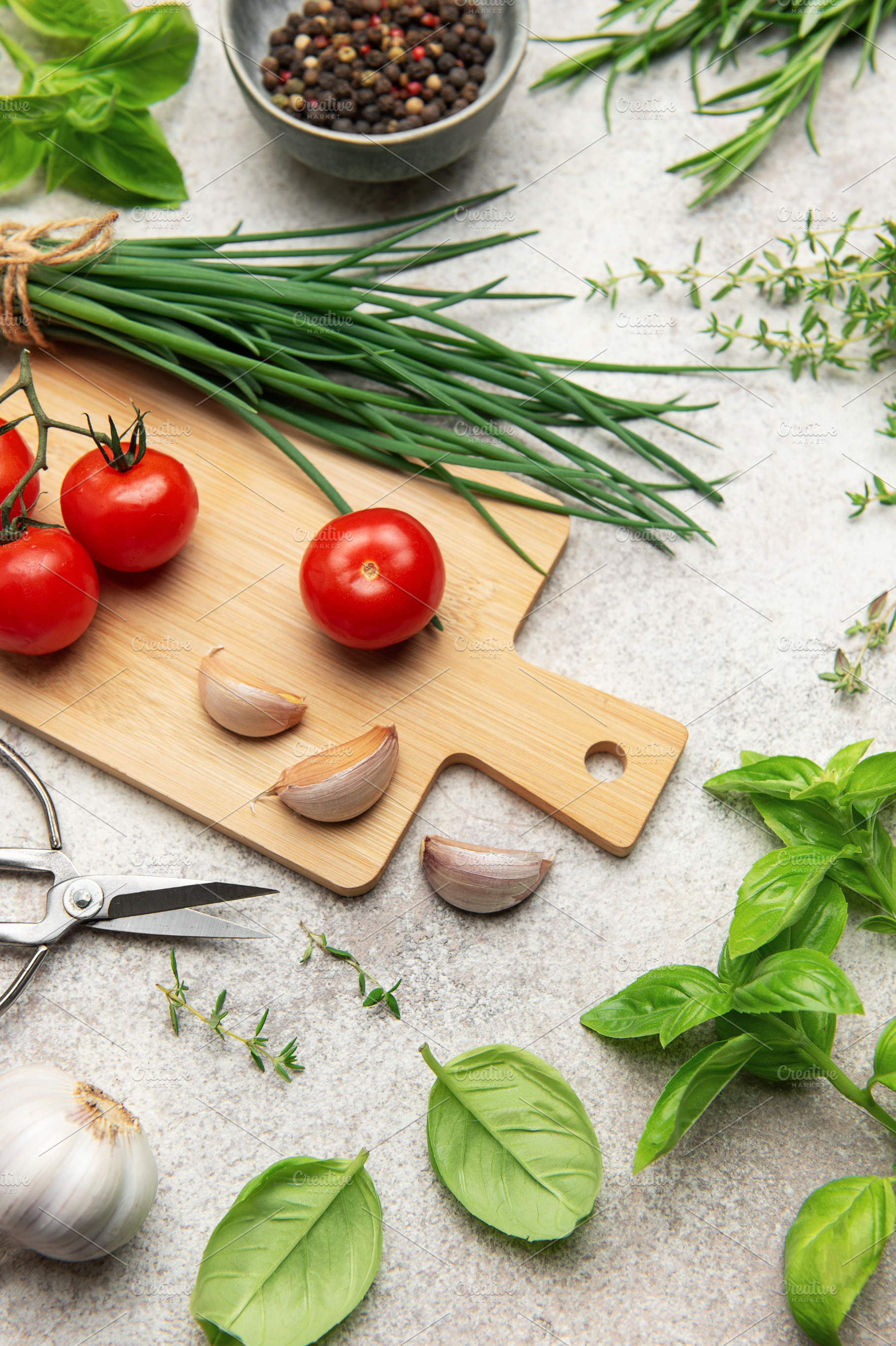 Fresh herbs, spices, tomatoes and garlic creating a frame on kit, a Food & Drink Photo by Olena Rudo