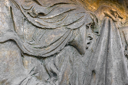 Bas-relief face of a suffering woman