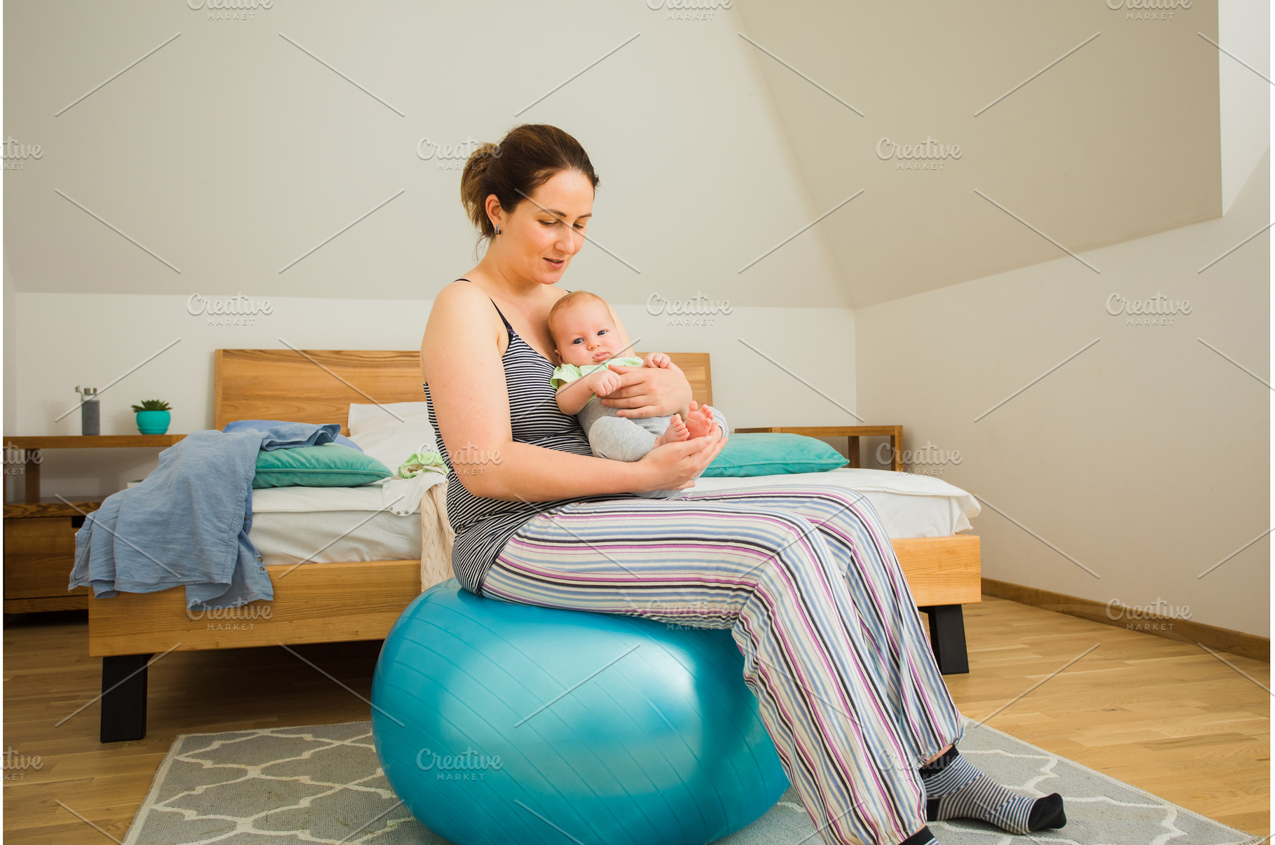 Mother holding and rocking baby, a Person Photo by oksix