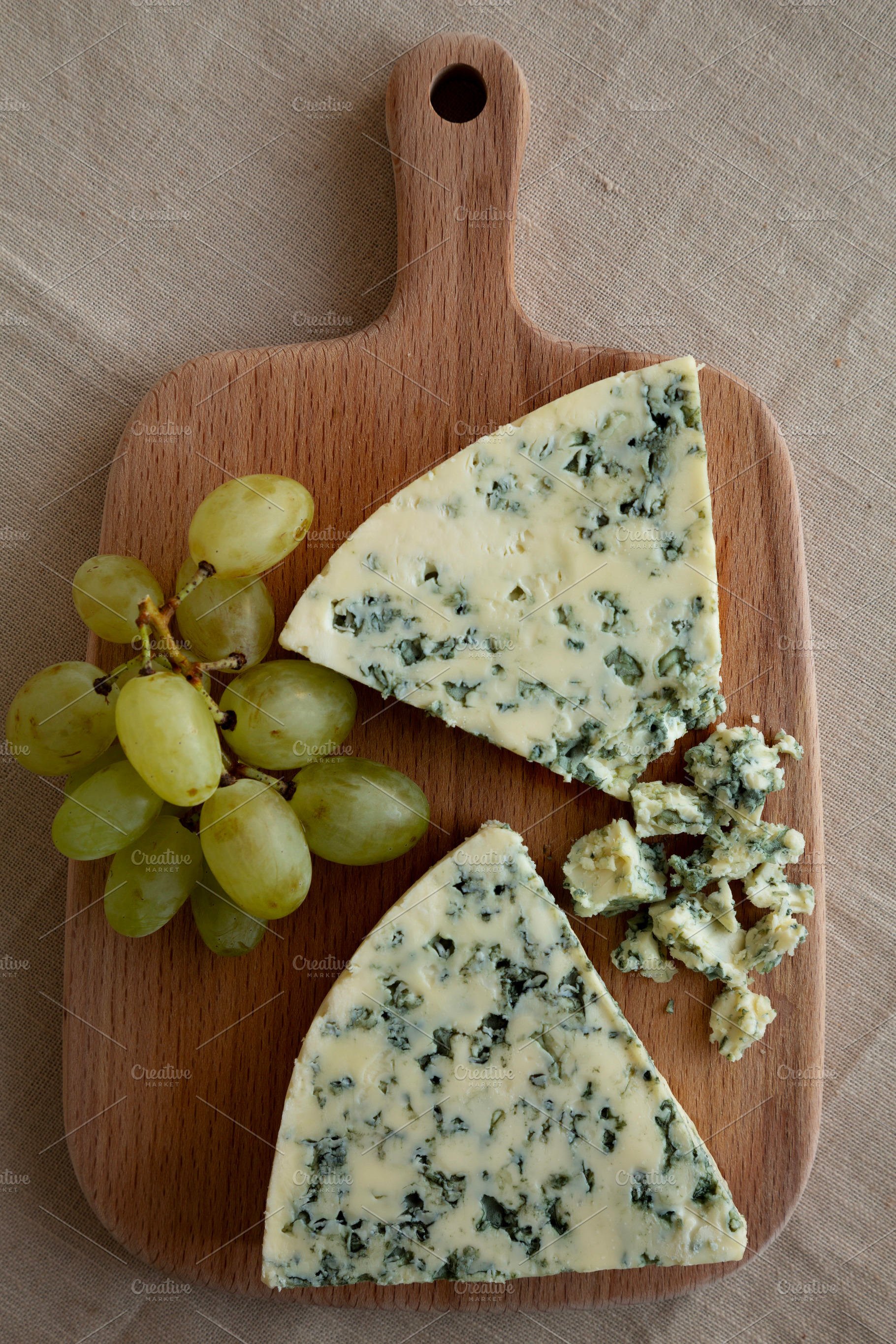 Delicious Cheese Danablu on a wooden board, top view., a Food & Drink Photo by LiudmylaChuhunova
