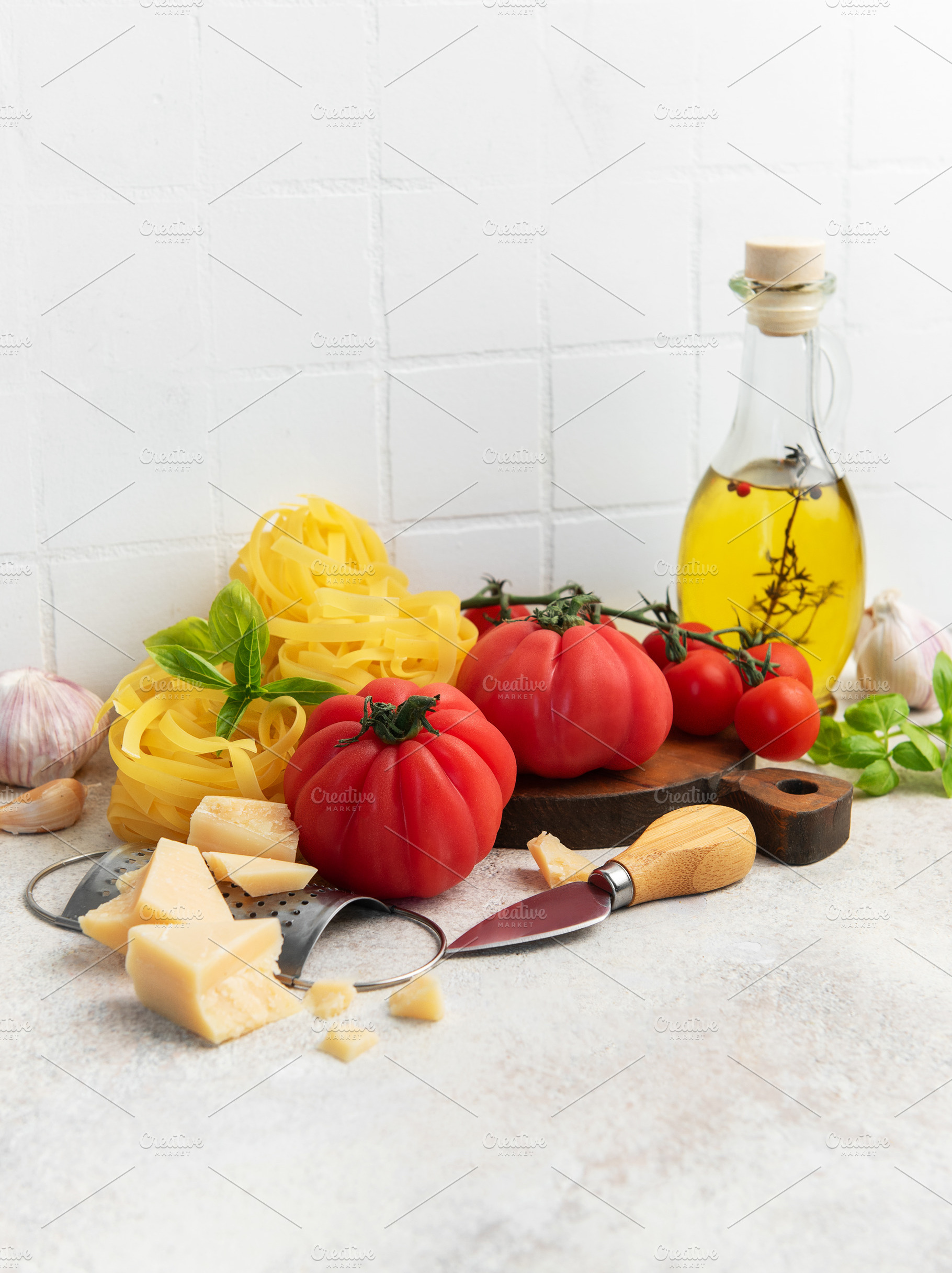 Fresh italian ingredients preparing pasta with tomatoes and basi, a Food & Drink Photo by Olena Rudo