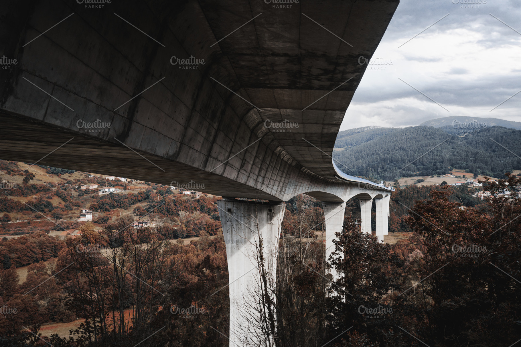Curved bridge over autumn valley, an Architecture Photo by SkyNext