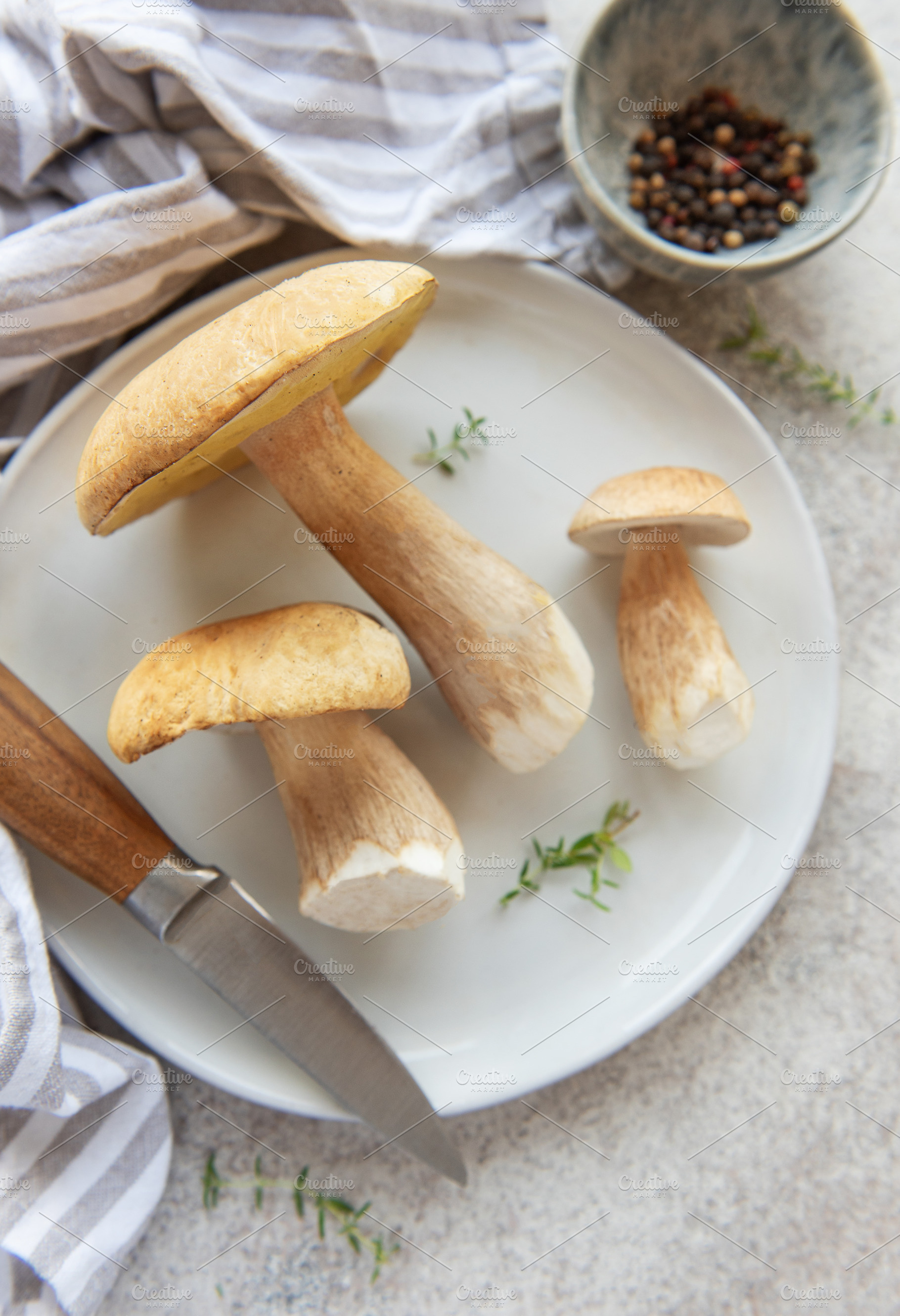 Fresh penny bun mushrooms ready for cooking on white plate, a Food & Drink Photo by Olena Rudo