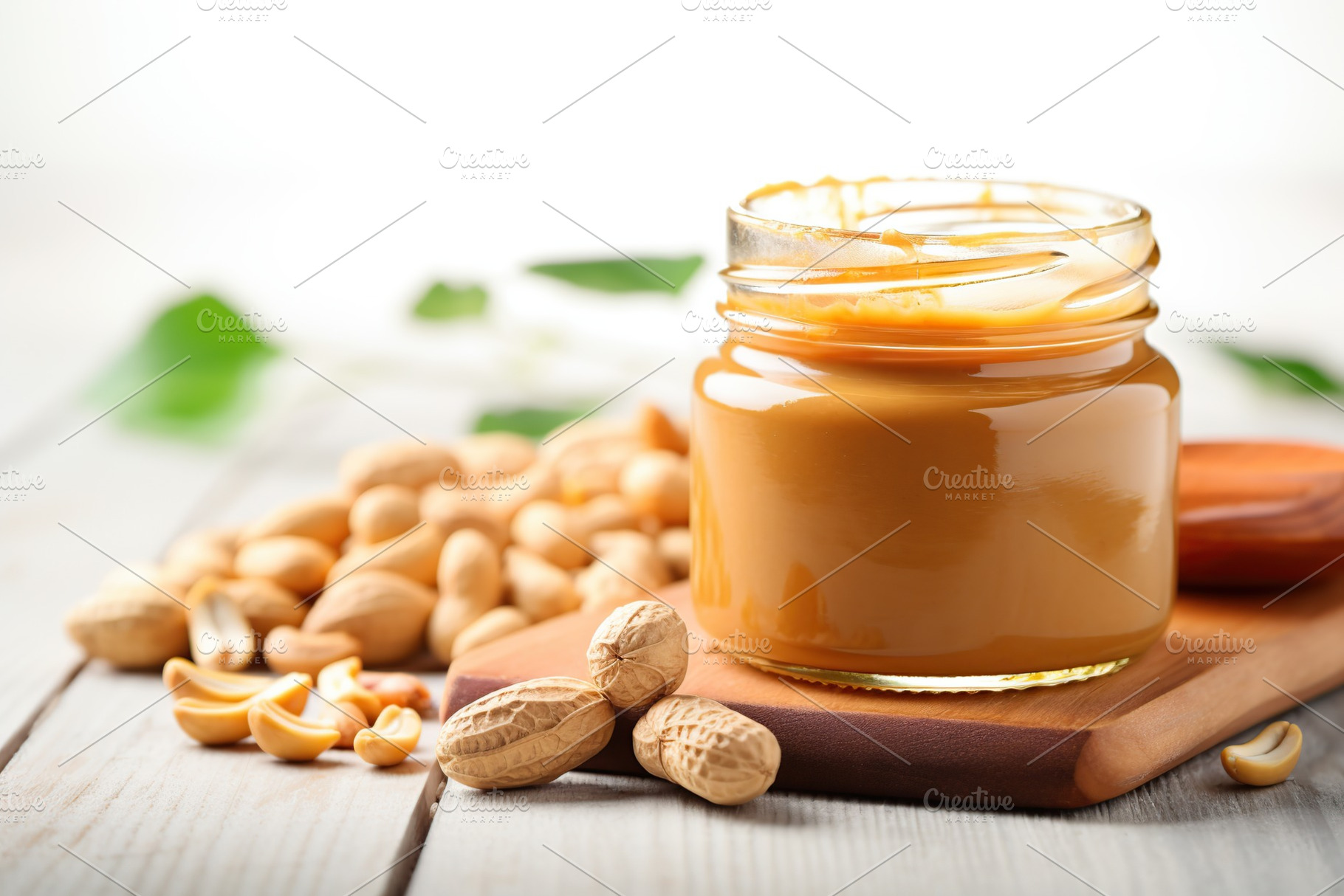 Glass jar with peanut butter on wooden background, a Food & Drink Photo by AlyaAnd