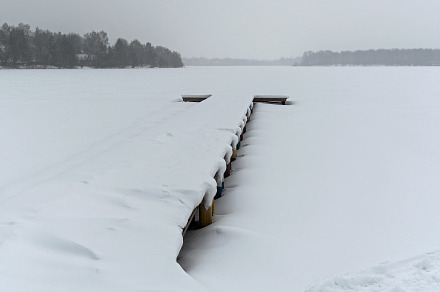 Snow-covered berth on a frozen lake.