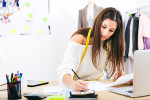 Working on office desk stock photo containing woman and designer