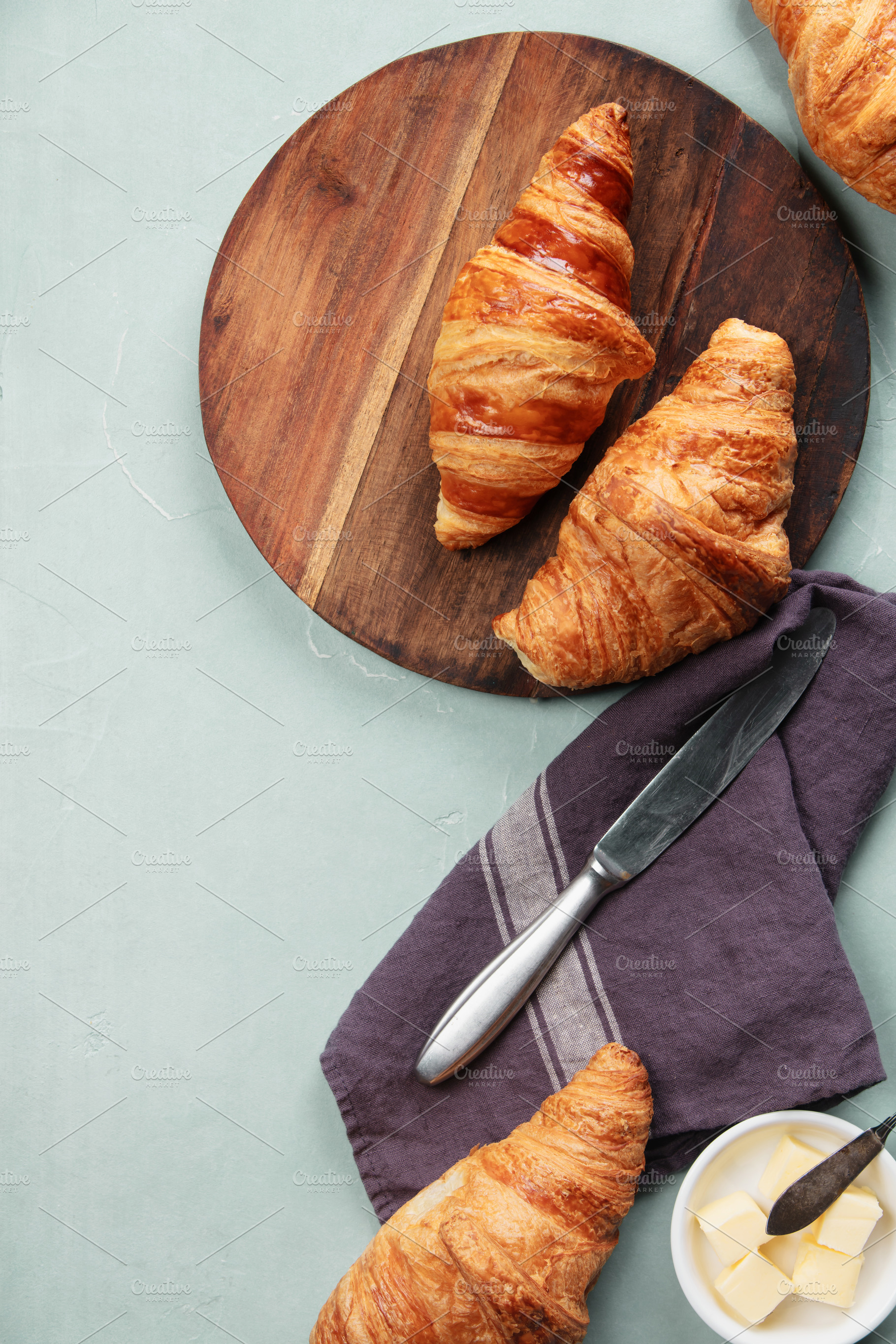 Fresh Croissants on Wooden Board with Butter and Knife, a Food & Drink Photo by Natalia Klenova's Shop