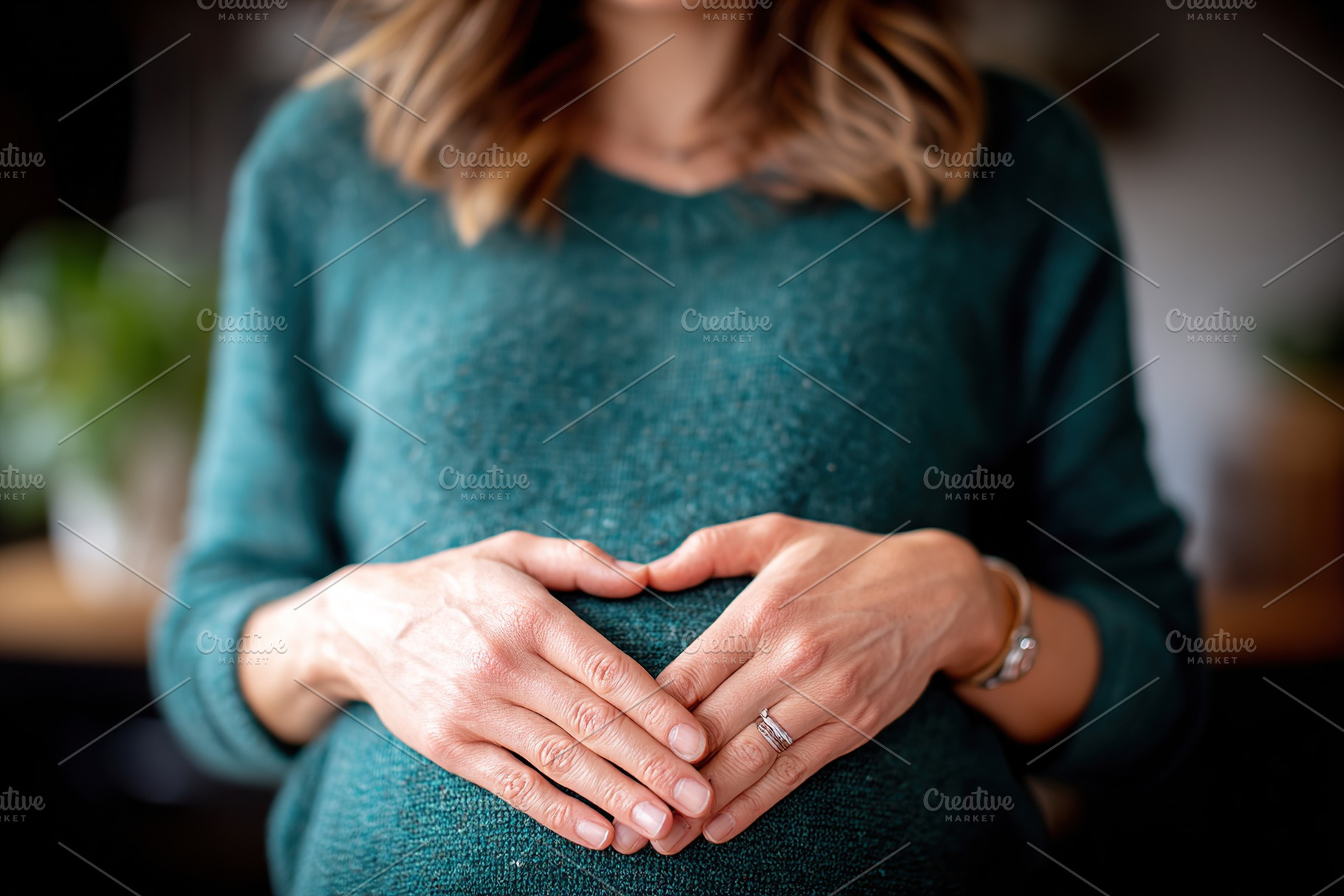 Pregnant woman gently cradling her baby bump with both hands indoors, a Person Photo by AlyaAnd