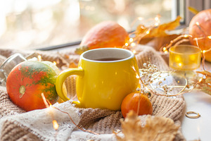 Fall leaves with cup of coffee containing autumn, background, and bokeh